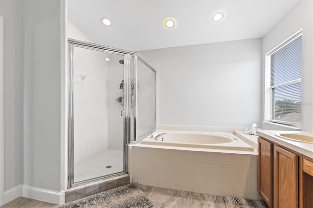 bathroom with vanity and independent shower and bath