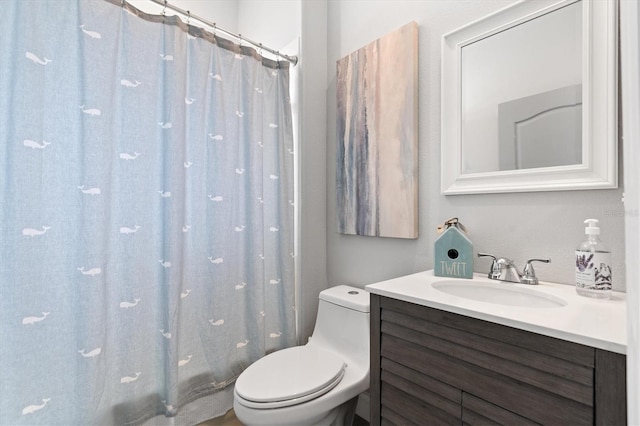 bathroom featuring toilet and large vanity