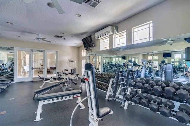 gym with a wall mounted air conditioner, french doors, a textured ceiling, and ceiling fan