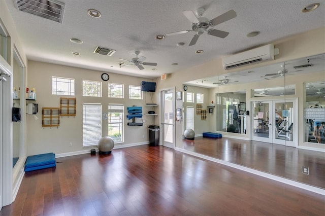 gym featuring french doors, ceiling fan, and dark wood-type flooring