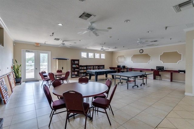 tiled dining area featuring a textured ceiling, ceiling fan, french doors, and crown molding