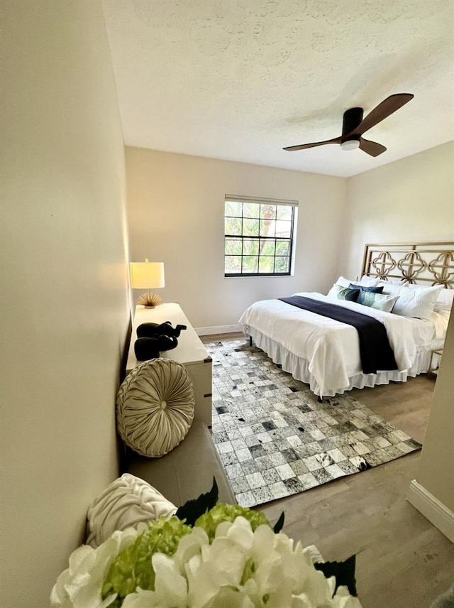 bedroom featuring a textured ceiling and ceiling fan