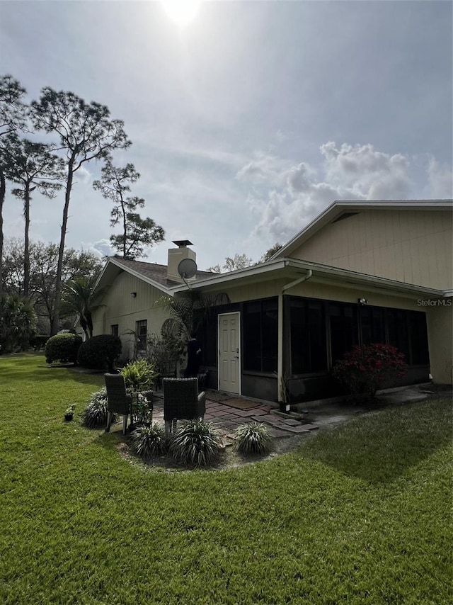 view of property exterior featuring a yard and a patio area