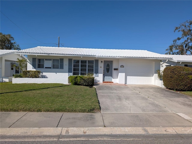 ranch-style house featuring an attached garage, a tiled roof, driveway, stucco siding, and a front lawn