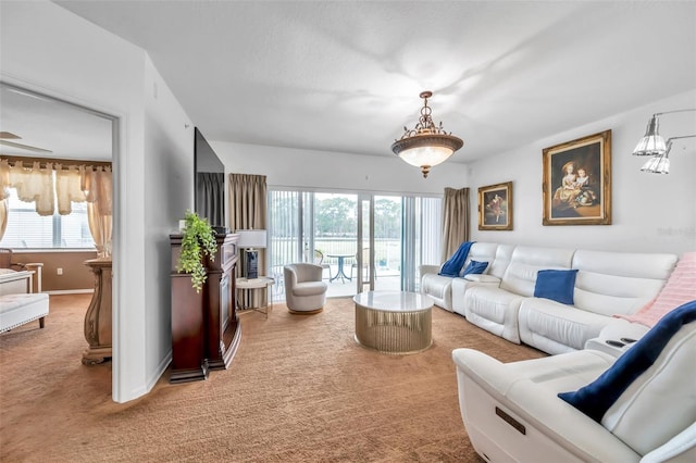 living room with baseboards and light colored carpet