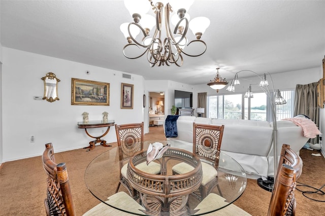 dining room with baseboards, carpet, visible vents, and an inviting chandelier