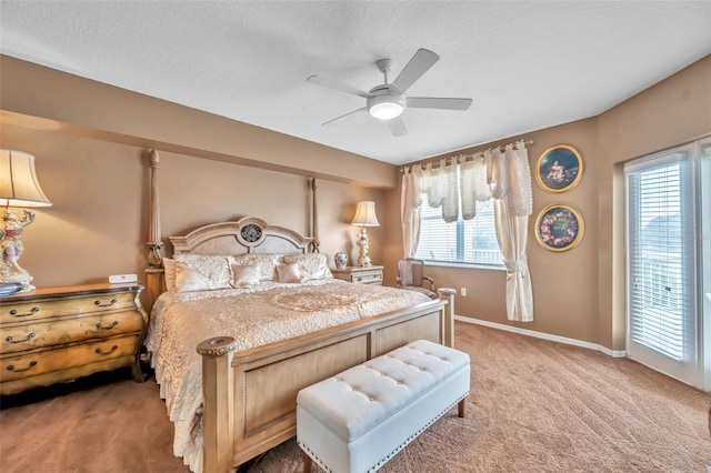 bedroom with ceiling fan, baseboards, a textured ceiling, and light colored carpet