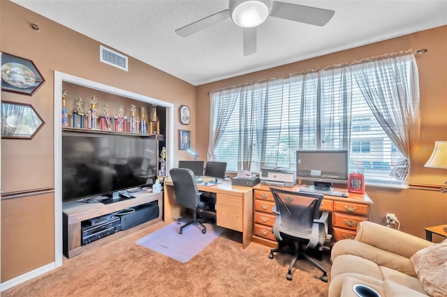 office area with carpet floors, ceiling fan, visible vents, and a textured ceiling