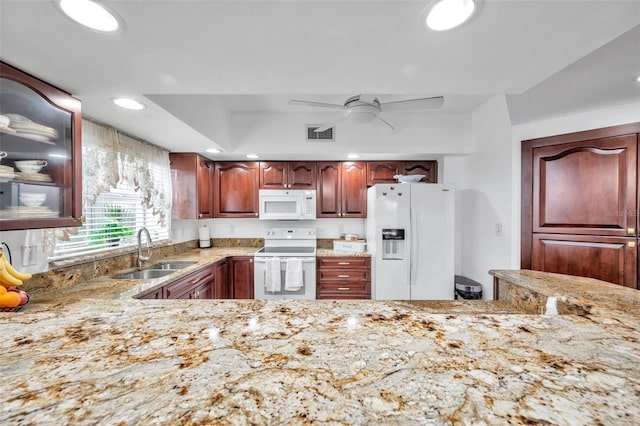 kitchen featuring light stone counters, recessed lighting, a ceiling fan, a sink, and white appliances