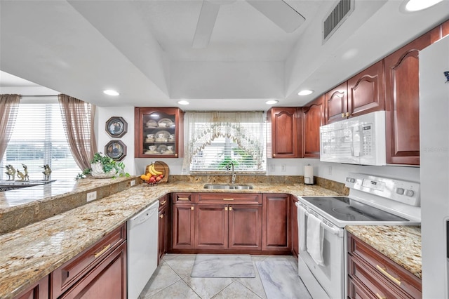 kitchen featuring white appliances, visible vents, a wealth of natural light, and a sink