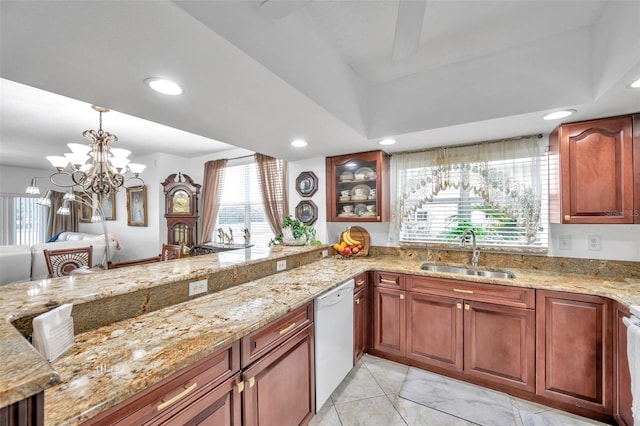 kitchen featuring light stone counters, recessed lighting, stove, a sink, and dishwasher