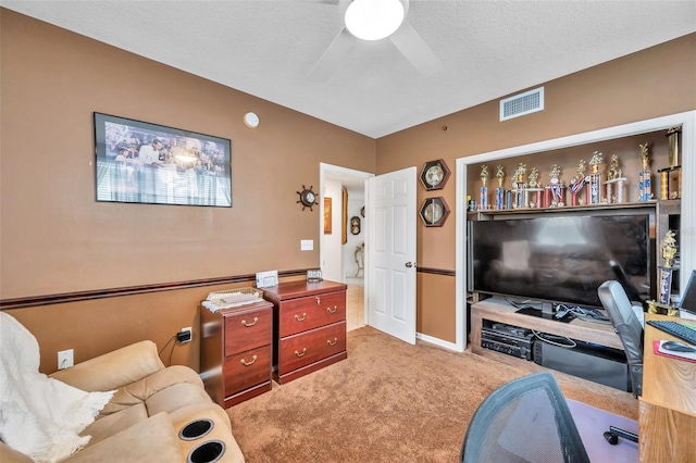 interior space featuring a textured ceiling, visible vents, and a ceiling fan