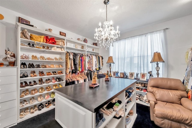 spacious closet with a chandelier