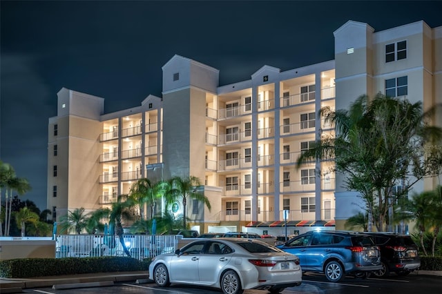 property at night featuring uncovered parking