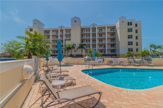 pool featuring a patio area and fence