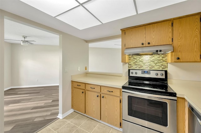 kitchen featuring ceiling fan, decorative backsplash, light hardwood / wood-style flooring, and appliances with stainless steel finishes