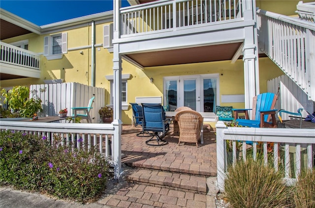 view of patio / terrace with french doors and a balcony