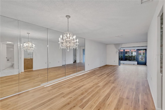 interior space featuring a textured ceiling and a notable chandelier