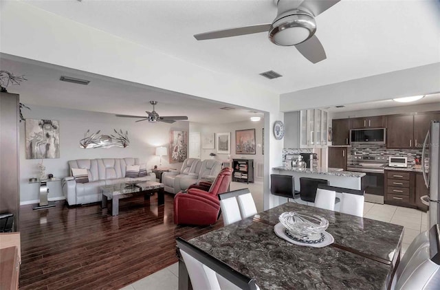 dining space featuring ceiling fan and light hardwood / wood-style flooring