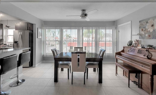 tiled dining space with ceiling fan