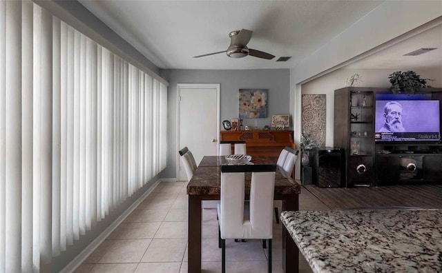 dining room with light tile flooring and ceiling fan