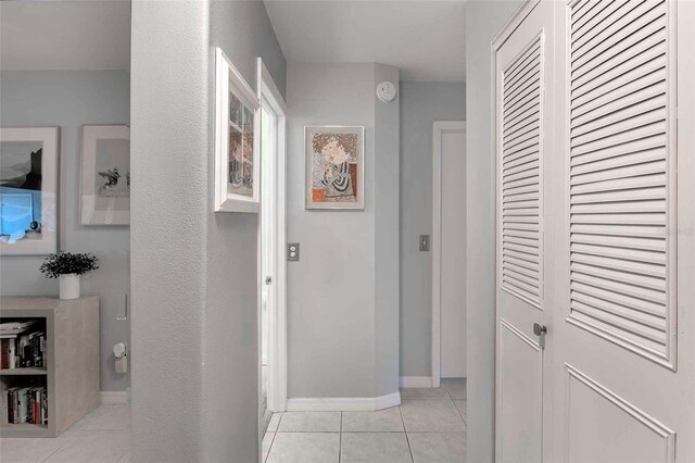 hallway featuring light tile floors