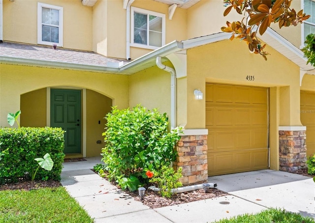 entrance to property with covered porch and a garage