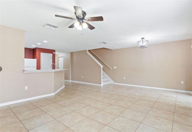 empty room with ceiling fan and light tile floors