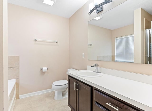 bathroom with vanity, tile flooring, a bath to relax in, and toilet