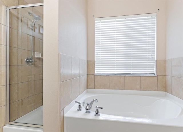 bathroom featuring shower with separate bathtub and a wealth of natural light