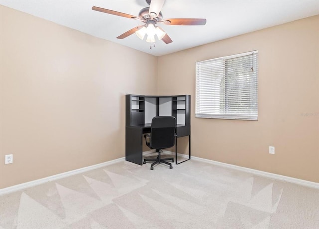 carpeted office space with ceiling fan