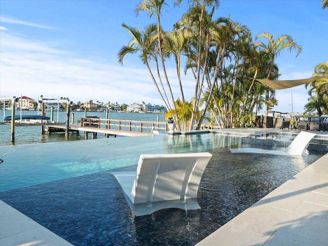 exterior space featuring pool water feature, a water view, and a boat dock