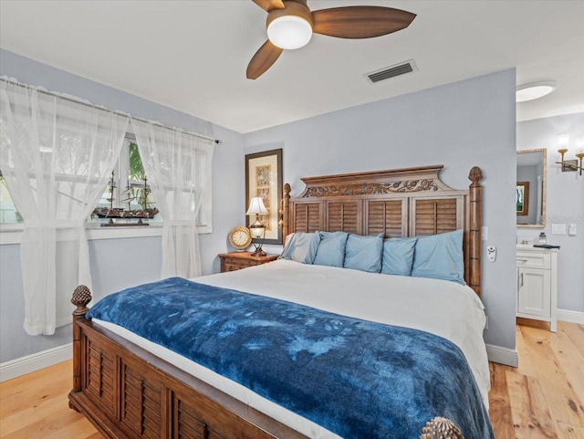 bedroom with light hardwood / wood-style floors and ceiling fan