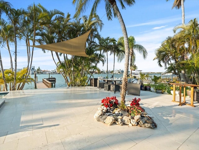 view of front of property with a water view and a patio area