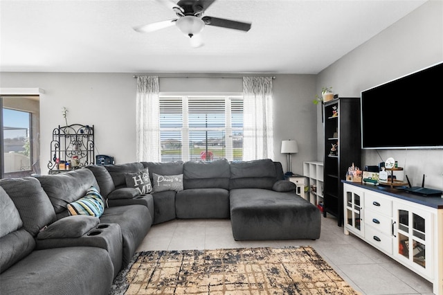 living area with light tile patterned flooring and a ceiling fan