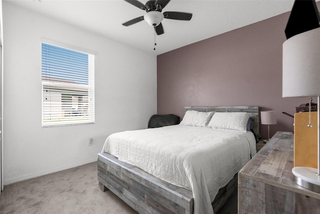 bedroom featuring baseboards, a ceiling fan, and light colored carpet