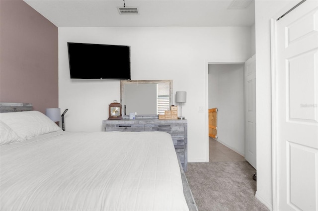 carpeted bedroom featuring baseboards and visible vents