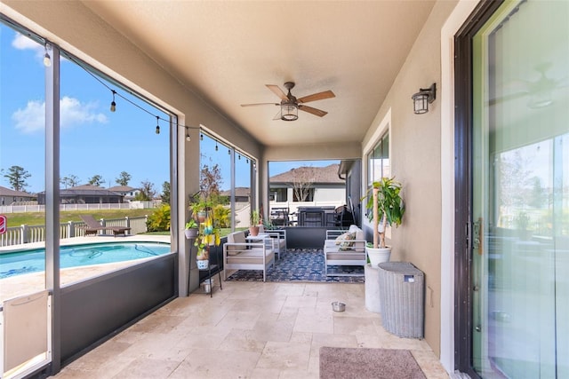 sunroom / solarium featuring ceiling fan