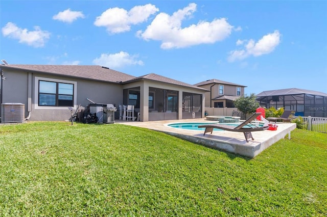 rear view of property with a sunroom, fence, a yard, central AC, and stucco siding