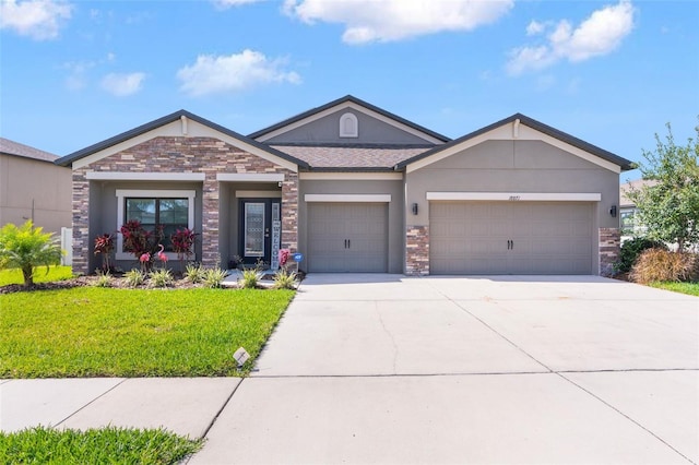 view of front of house with a garage, concrete driveway, stone siding, stucco siding, and a front lawn