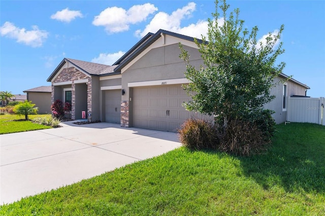 ranch-style home featuring a garage, concrete driveway, stone siding, stucco siding, and a front yard