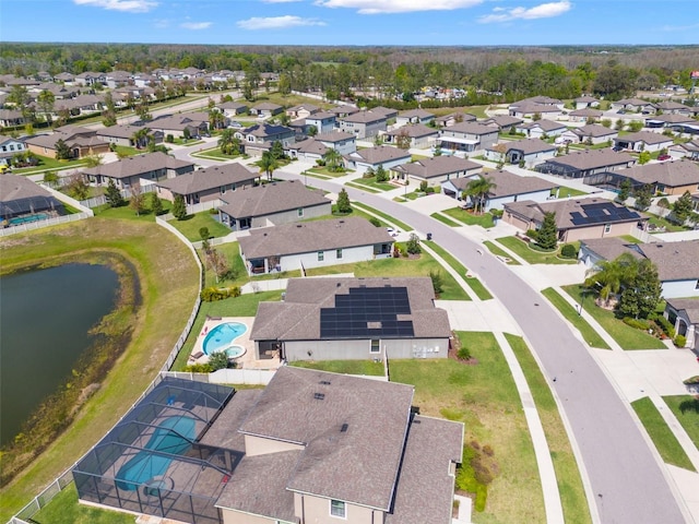 drone / aerial view with a water view and a residential view