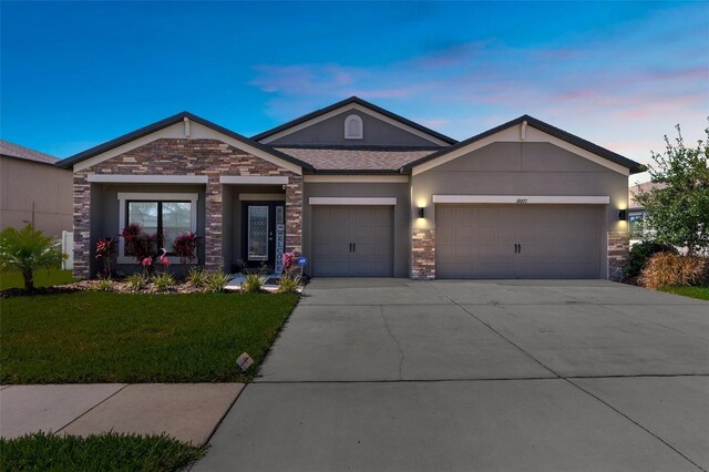 view of front of property with a lawn and a garage