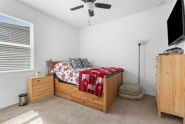 bedroom featuring light carpet and ceiling fan