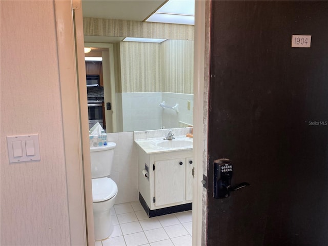 bathroom with tile patterned flooring, vanity, and toilet