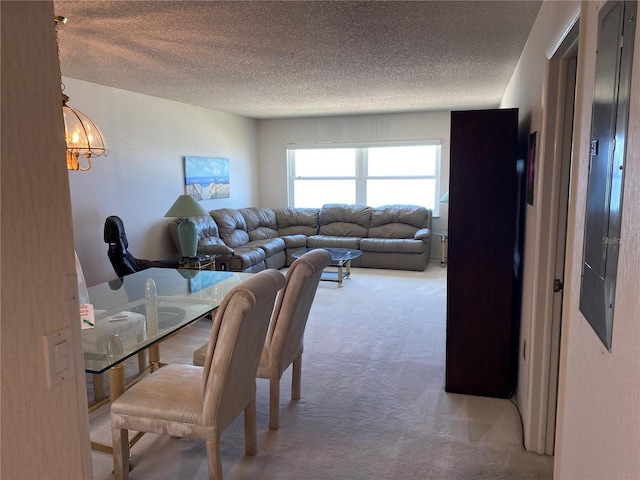 carpeted dining room featuring a textured ceiling