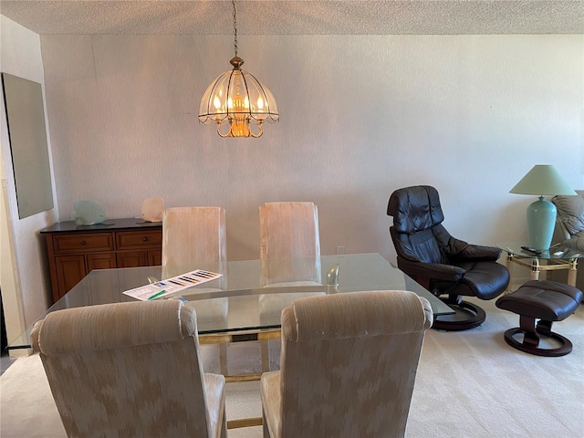 carpeted dining room with a chandelier and a textured ceiling