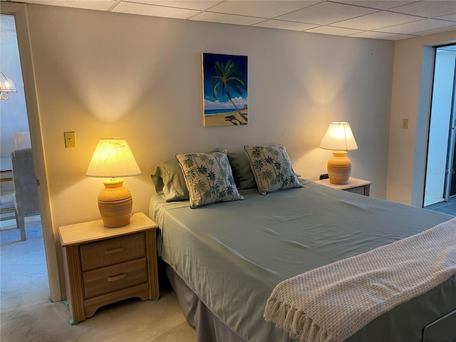 carpeted bedroom with a drop ceiling