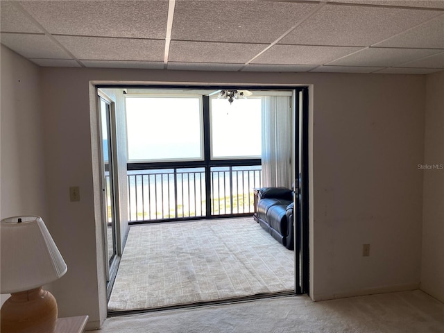 unfurnished living room with carpet and a drop ceiling