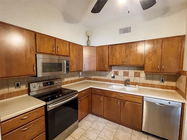 kitchen featuring light tile floors, ceiling fan, appliances with stainless steel finishes, and sink